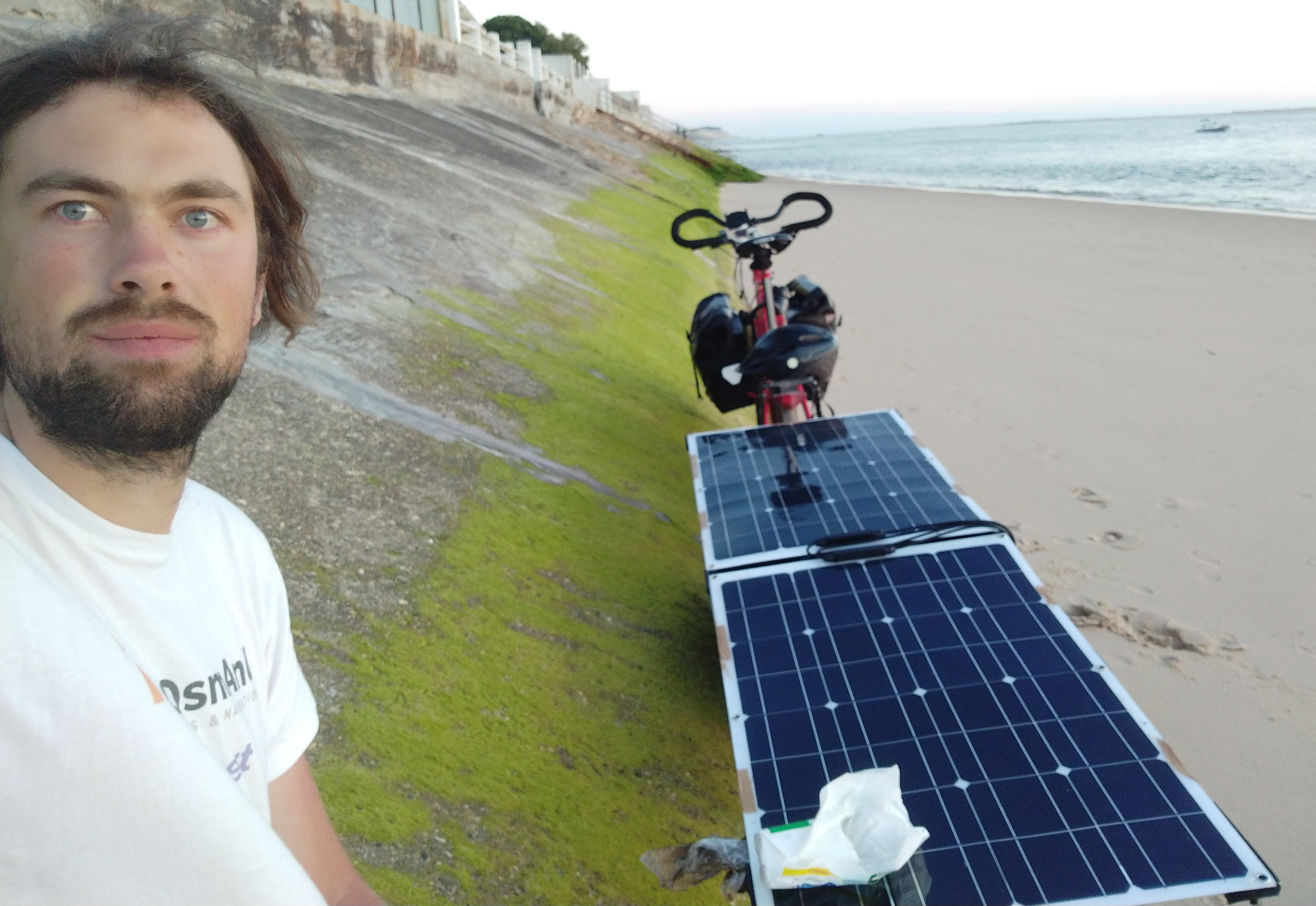 Trailer with soler panels in the riding configuration. And me, happy that I made it to the beach!